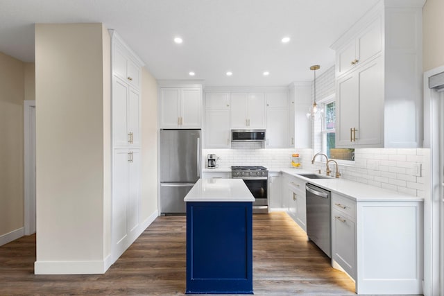 11955 84th Pl N, Maple Grove, MN 55369 - kitchen featuring stainless steel appliances, a sink, a kitchen island, tasteful backsplash, and white cabinetry