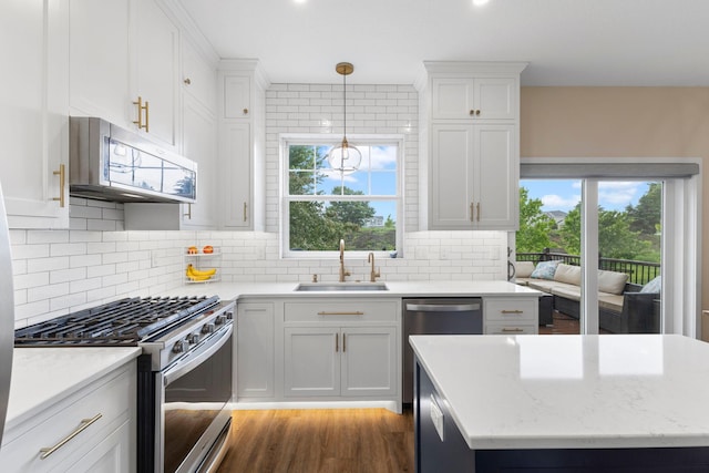 11955 84th Pl N, Maple Grove, MN 55369 - kitchen with stainless steel appliances, a sink, white cabinets, and decorative backsplash