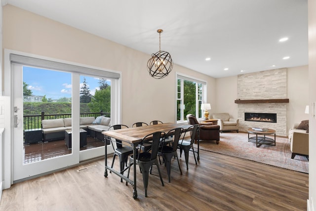 11955 84th Pl N, Maple Grove, MN 55369 - dining area with wood finished floors, a stone fireplace, and recessed lighting