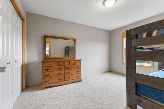 11955 84th Pl N, Maple Grove, MN 55369 - carpeted bedroom with baseboards, a closet, and a textured ceiling