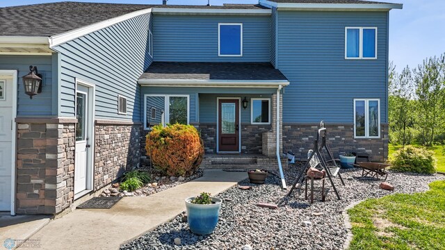 6056 170th Ave SE, Walcott, ND 58077 - back of property with a shingled roof and stone siding