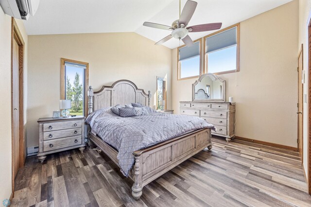 6056 170th Ave SE, Walcott, ND 58077 - bedroom featuring multiple windows, lofted ceiling, wood finished floors, a baseboard heating unit, and a ceiling fan