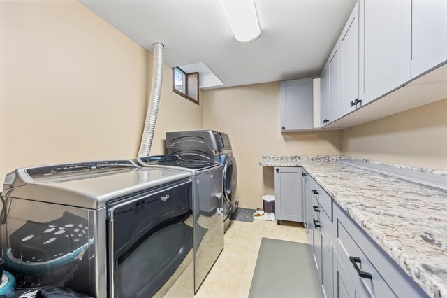 6056 170th Ave SE, Walcott, ND 58077 - laundry room with cabinet space, washer and clothes dryer, and light tile patterned floors
