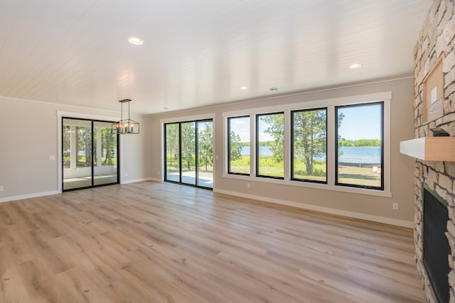 29655 E Horseshoe Lake Rd, Mission Twp, MN 56465 - unfurnished living room with a fireplace, a chandelier, light wood finished floors, baseboards, and recessed lighting