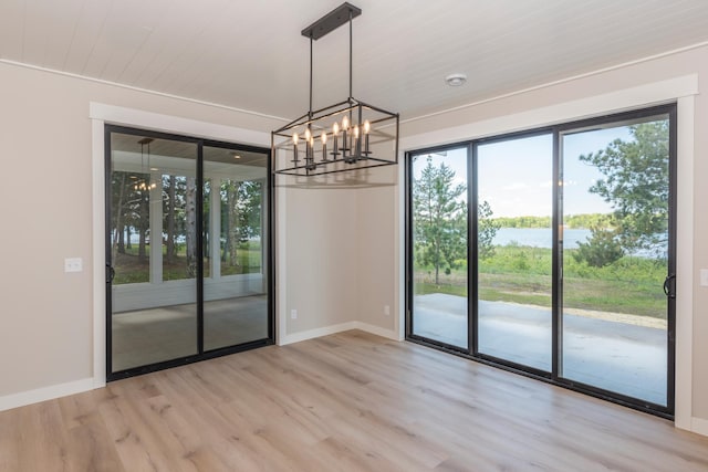 29655 E Horseshoe Lake Rd, Mission Twp, MN 56465 - unfurnished room with light wood-type flooring, a chandelier, and baseboards