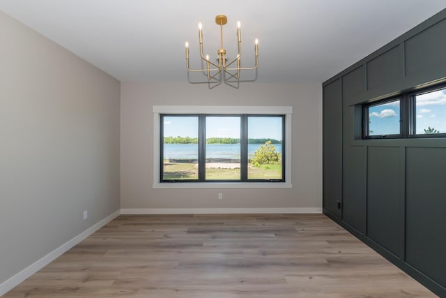 29655 E Horseshoe Lake Rd, Mission Twp, MN 56465 - unfurnished dining area featuring a chandelier, baseboards, and light wood-style floors