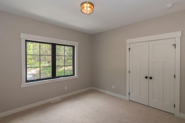 29655 E Horseshoe Lake Rd, Mission Twp, MN 56465 - unfurnished bedroom with light colored carpet, baseboards, and a closet