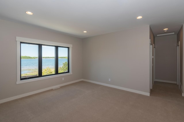 29655 E Horseshoe Lake Rd, Mission Twp, MN 56465 - spare room featuring light carpet, recessed lighting, baseboards, and a water view