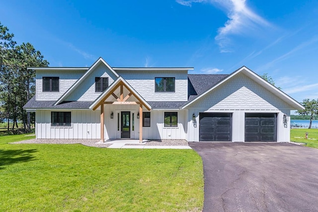 29655 E Horseshoe Lake Rd, Mission Twp, MN 56465 - modern farmhouse style home featuring a garage, asphalt driveway, a front lawn, and board and batten siding