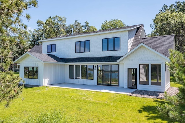 29655 E Horseshoe Lake Rd, Mission Twp, MN 56465 - back of house with roof with shingles, a patio area, a yard, and board and batten siding
