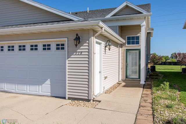 828 Cinnamon Ridge Pl, West Fargo, ND 58078 - entrance to property with roof with shingles, a lawn, central AC unit, and an attached garage