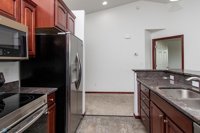 828 Cinnamon Ridge Pl, West Fargo, ND 58078 - kitchen with stainless steel appliances, dark stone counters, a sink, baseboards, and recessed lighting