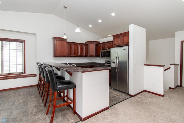 828 Cinnamon Ridge Pl, West Fargo, ND 58078 - kitchen with appliances with stainless steel finishes, lofted ceiling, a kitchen bar, baseboards, and a peninsula