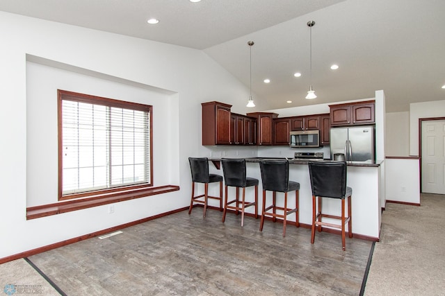 828 Cinnamon Ridge Pl, West Fargo, ND 58078 - kitchen featuring stainless steel appliances, a peninsula, lofted ceiling, recessed lighting, and baseboards