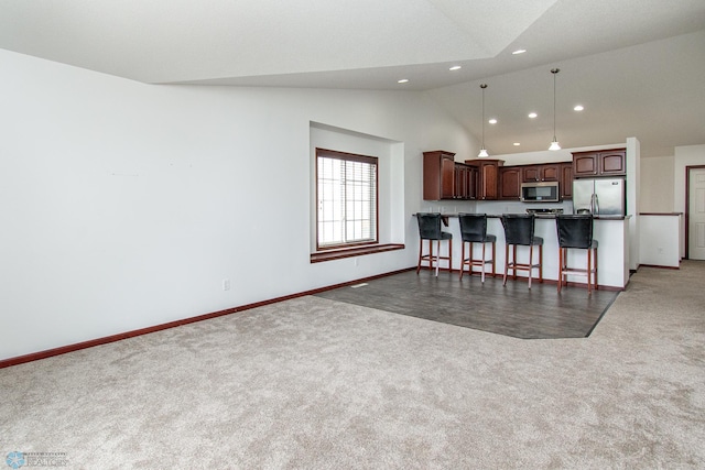 828 Cinnamon Ridge Pl, West Fargo, ND 58078 - kitchen featuring appliances with stainless steel finishes, carpet flooring, recessed lighting, lofted ceiling, and open floor plan