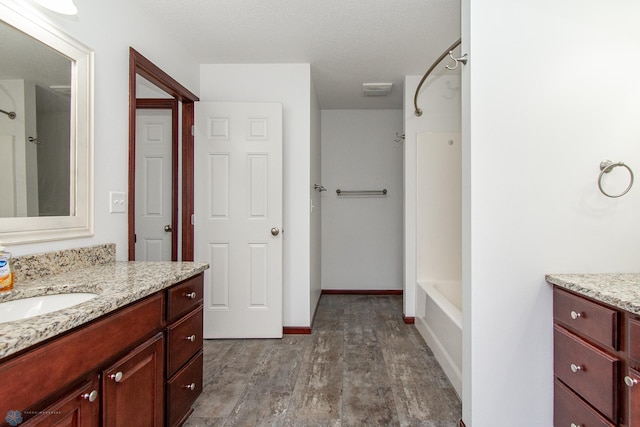 828 Cinnamon Ridge Pl, West Fargo, ND 58078 - full bathroom with vanity, wood finished floors, and washtub / shower combination