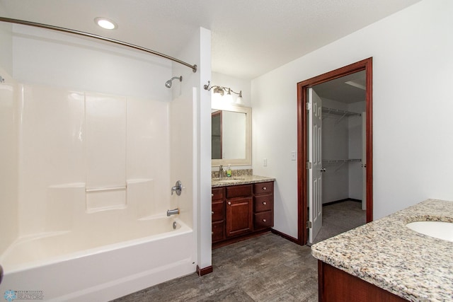 828 Cinnamon Ridge Pl, West Fargo, ND 58078 - bathroom with vanity, shower / washtub combination, a spacious closet, recessed lighting, and wood finished floors