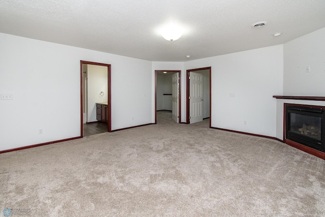 828 Cinnamon Ridge Pl, West Fargo, ND 58078 - unfurnished living room with carpet, baseboards, and a glass covered fireplace