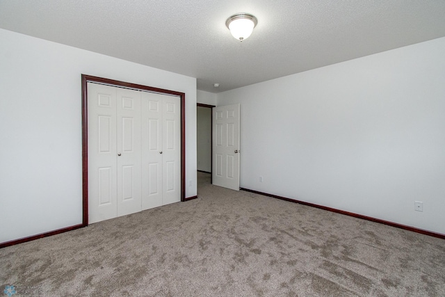 828 Cinnamon Ridge Pl, West Fargo, ND 58078 - unfurnished bedroom featuring carpet floors, a closet, and baseboards