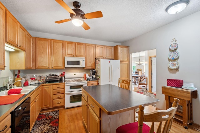 17830 Glasgow Way, Lakeville, MN 55044 - kitchen with white appliances, a sink, light wood-style floors, ceiling fan, and a breakfast bar