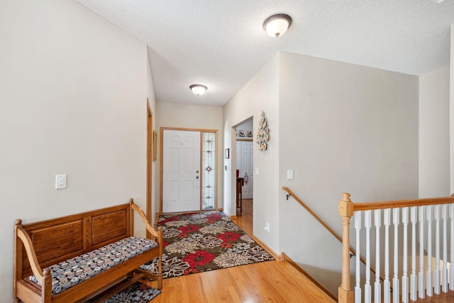 17830 Glasgow Way, Lakeville, MN 55044 - entryway featuring wood finished floors, a textured ceiling, and baseboards