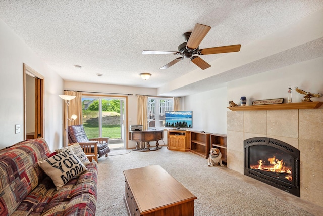 17830 Glasgow Way, Lakeville, MN 55044 - living area featuring a textured ceiling, a tiled fireplace, a ceiling fan, and light carpet