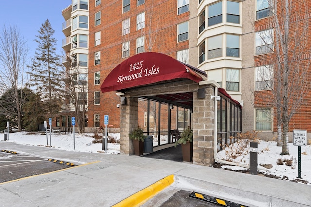 1425 28th St Unit 510, Minneapolis, MN 55408 - snow covered building featuring uncovered parking and a view of apartment building / complex