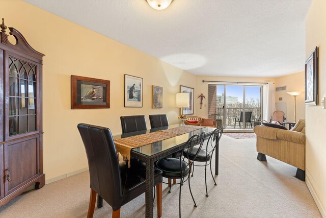 1425 28th St Unit 510, Minneapolis, MN 55408 - dining area featuring light carpet and baseboards
