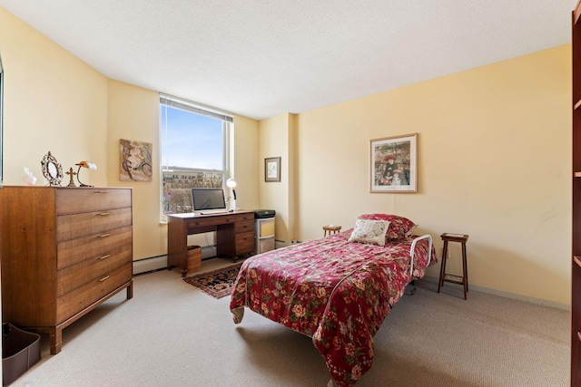 1425 28th St Unit 510, Minneapolis, MN 55408 - bedroom with carpet floors, a desk, baseboards, a baseboard radiator, and a baseboard heating unit