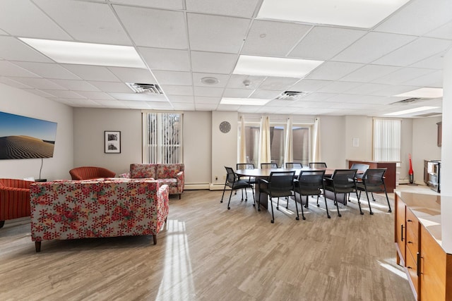 1425 28th St Unit 510, Minneapolis, MN 55408 - living area featuring light wood-type flooring and a paneled ceiling