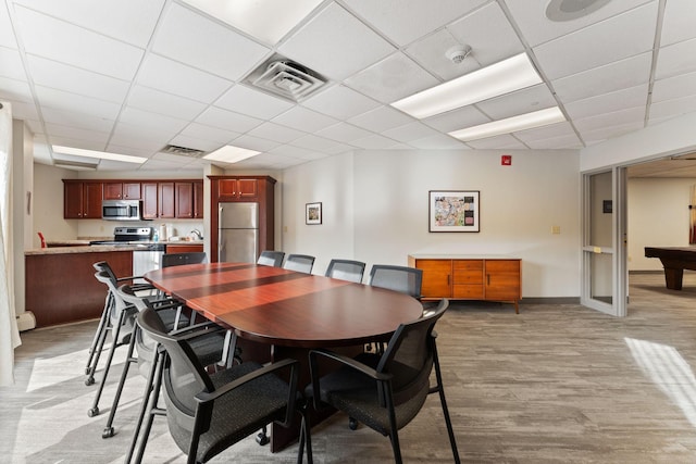 1425 28th St Unit 510, Minneapolis, MN 55408 - dining area featuring a drop ceiling, light wood-type flooring, and baseboards