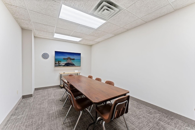 1425 28th St Unit 510, Minneapolis, MN 55408 - dining room featuring carpet floors, baseboards, and a paneled ceiling