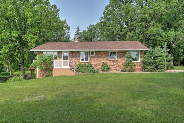 2509 Jade St, Mora, MN 55051 - ranch-style house with brick siding, a front lawn, and a chimney