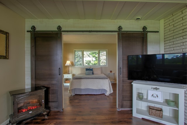 2509 Jade St, Mora, MN 55051 - bedroom with a barn door, wood finished floors, and a wood stove