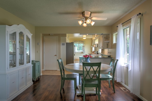 2509 Jade St, Mora, MN 55051 - dining room featuring a textured ceiling, dark wood-style floors, and a ceiling fan