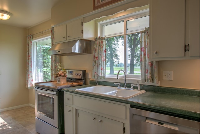 2509 Jade St, Mora, MN 55051 - kitchen with appliances with stainless steel finishes, under cabinet range hood, dark countertops, and white cabinets