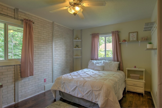 2509 Jade St, Mora, MN 55051 - bedroom with brick wall, dark wood-style flooring, and ceiling fan