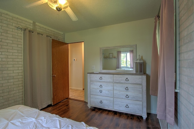 2509 Jade St, Mora, MN 55051 - bedroom featuring dark wood-style flooring, brick wall, and ceiling fan