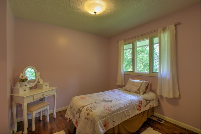 2509 Jade St, Mora, MN 55051 - bedroom with dark wood-style flooring and a textured ceiling