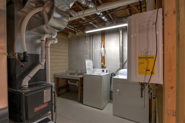2509 Jade St, Mora, MN 55051 - washroom featuring washing machine and dryer, concrete block wall, water heater, and heating unit