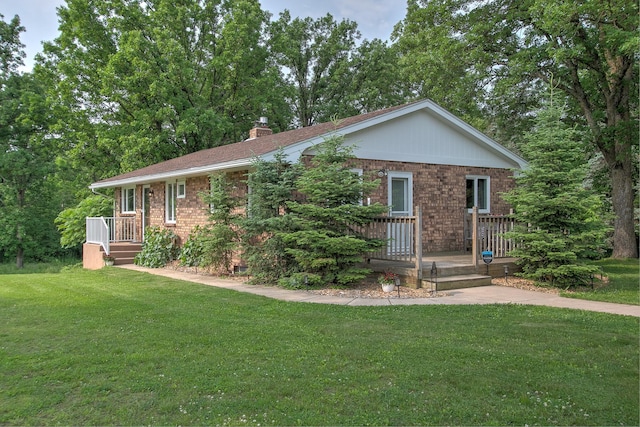 2509 Jade St, Mora, MN 55051 - view of front facade featuring brick siding, a front lawn, and a chimney