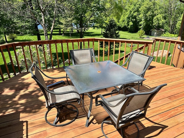 18819 329th Ave, Isle, MN 56342 - deck with outdoor dining area and a lawn