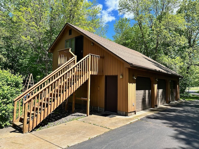 18819 329th Ave, Isle, MN 56342 - view of front facade with a shingled roof, stairs, and a garage