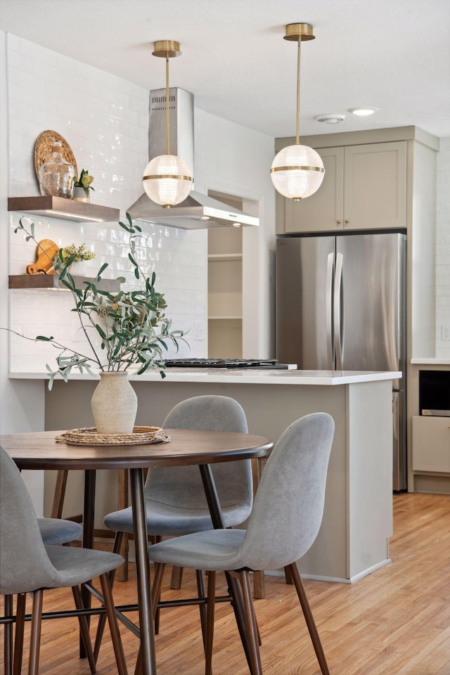 2930 Salem Ave, Saint Louis Park, MN 55416 - kitchen featuring light wood-type flooring, freestanding refrigerator, and hanging light fixtures