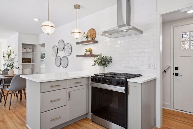 2930 Salem Ave, Saint Louis Park, MN 55416 - kitchen featuring range with gas stovetop, gray cabinets, wall chimney range hood, backsplash, and light wood-style flooring