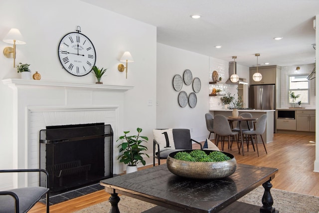 2930 Salem Ave, Saint Louis Park, MN 55416 - living area with light wood-style floors, a brick fireplace, and recessed lighting