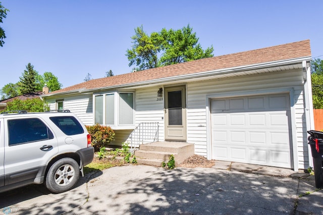 2009 7th St N, Fargo, ND 58102 - ranch-style home featuring driveway, a shingled roof, and an attached garage