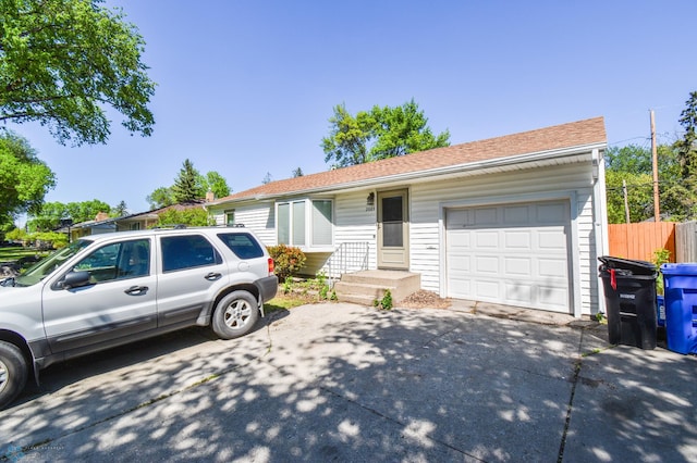 2009 7th St N, Fargo, ND 58102 - ranch-style house featuring driveway, an attached garage, and roof with shingles