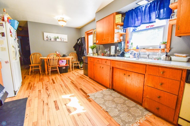 2009 7th St N, Fargo, ND 58102 - kitchen with a sink, white fridge with ice dispenser, light wood-type flooring, open shelves, and light countertops