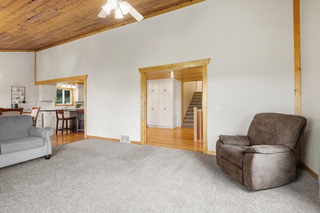 2487 2nd St SW, Buffalo, MN 55313 - living area with light colored carpet, wood ceiling, stairs, baseboards, and a ceiling fan